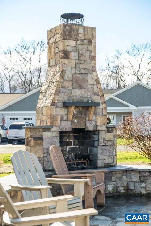 view of patio featuring an outdoor stone fireplace