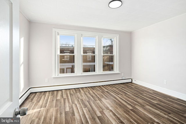 unfurnished room with ornamental molding, a baseboard heating unit, and hardwood / wood-style flooring