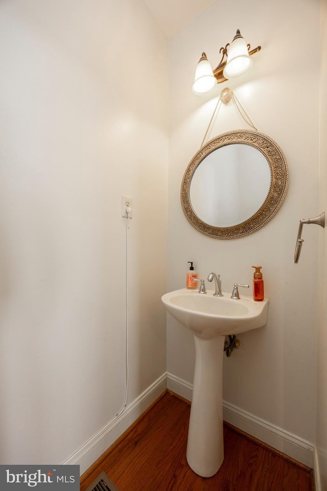 bathroom with sink and hardwood / wood-style flooring