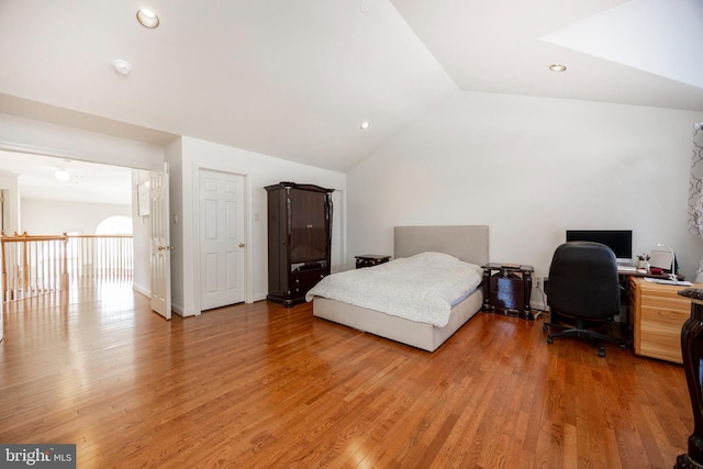 bedroom featuring hardwood / wood-style flooring and vaulted ceiling