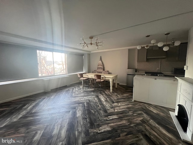 kitchen featuring dark parquet floors and stainless steel refrigerator