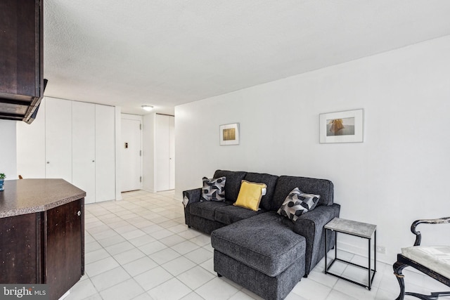 living room with light tile patterned floors and a textured ceiling