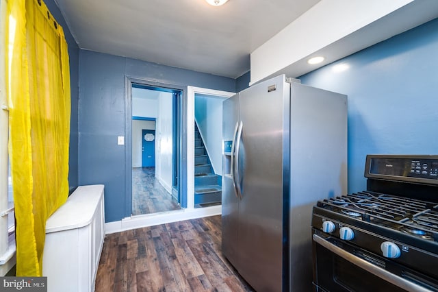 kitchen with stainless steel appliances and dark wood-type flooring