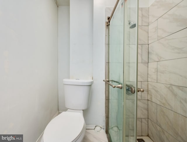 bathroom with an enclosed shower and toilet