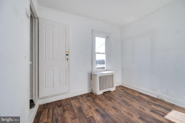 foyer featuring radiator heating unit and dark wood-type flooring