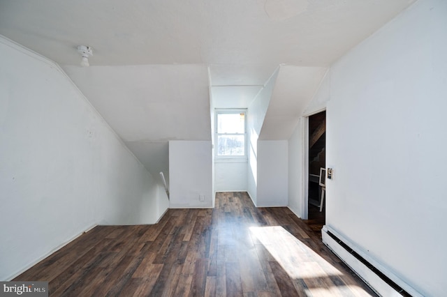 bonus room featuring dark hardwood / wood-style flooring, lofted ceiling, and a baseboard heating unit