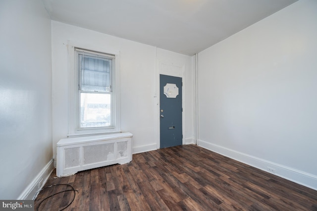 entrance foyer featuring dark hardwood / wood-style flooring and radiator