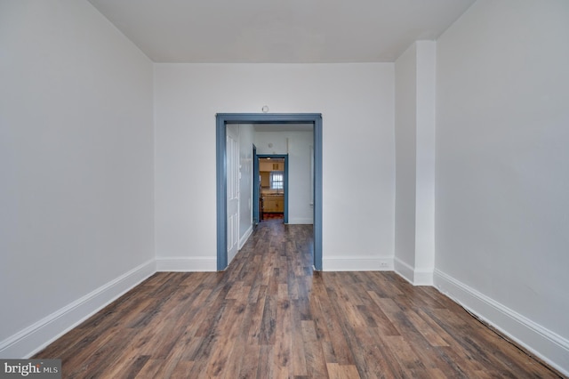 unfurnished room featuring dark hardwood / wood-style flooring