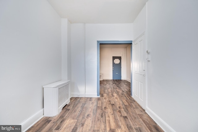 hallway featuring dark hardwood / wood-style flooring