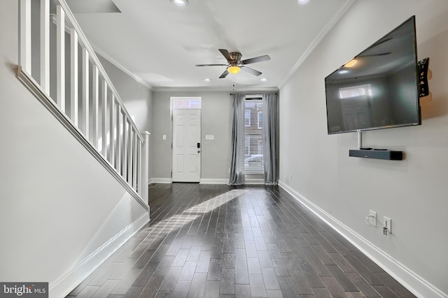 entryway featuring ceiling fan, dark wood-type flooring, and ornamental molding