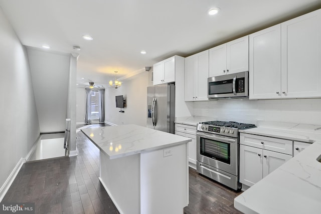 kitchen featuring white cabinets, light stone counters, and appliances with stainless steel finishes