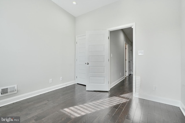 spare room featuring dark hardwood / wood-style floors