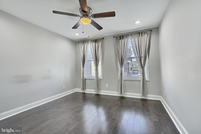 spare room with ceiling fan and dark wood-type flooring