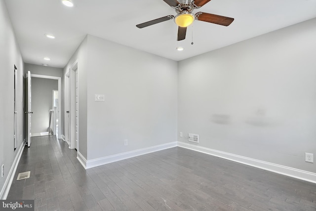 unfurnished room featuring ceiling fan and dark wood-type flooring