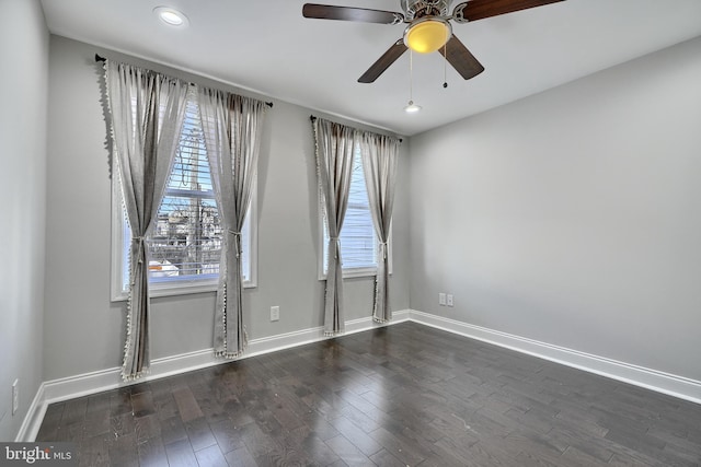 unfurnished room with ceiling fan and dark wood-type flooring