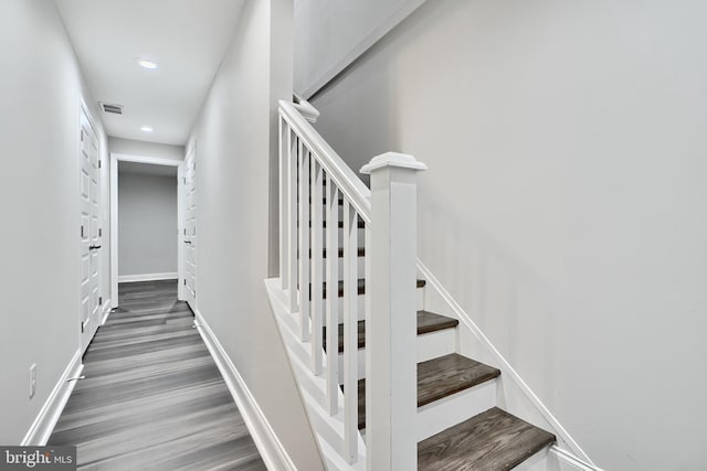 stairs with hardwood / wood-style floors