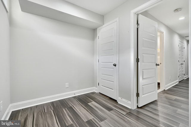 unfurnished bedroom with dark hardwood / wood-style flooring