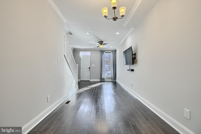 entrance foyer featuring ceiling fan with notable chandelier, dark hardwood / wood-style floors, and ornamental molding