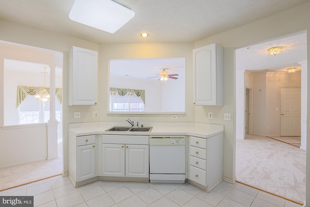 kitchen with sink, white cabinetry, light colored carpet, and white dishwasher