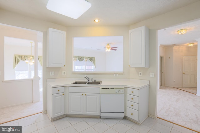 kitchen featuring sink, white cabinetry, white dishwasher, and light carpet