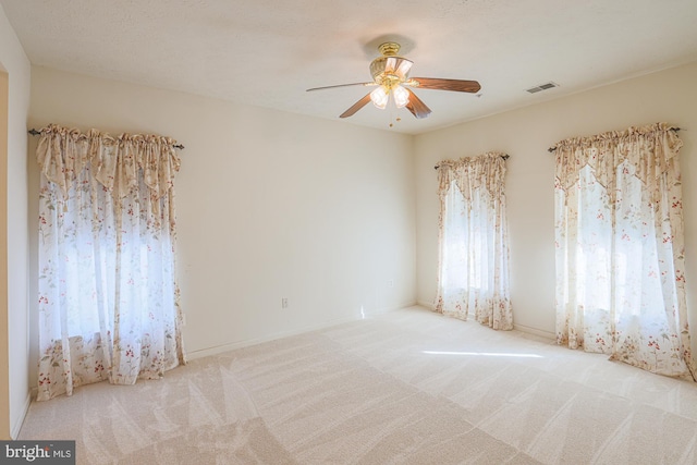 carpeted empty room with ceiling fan