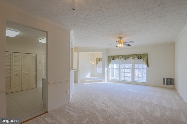 carpeted spare room featuring ceiling fan with notable chandelier, ornamental molding, and a textured ceiling