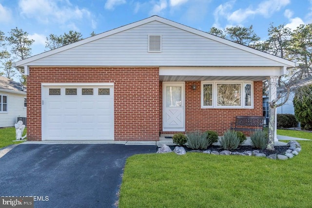 view of front of house featuring a garage and a front lawn