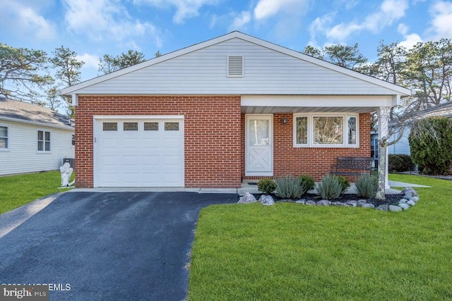 view of front of home with a garage and a front lawn