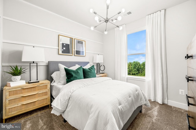 bedroom featuring dark colored carpet and a chandelier