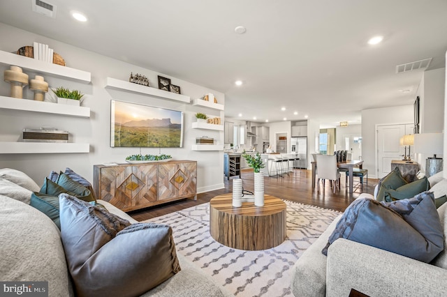 living room with hardwood / wood-style flooring and beverage cooler