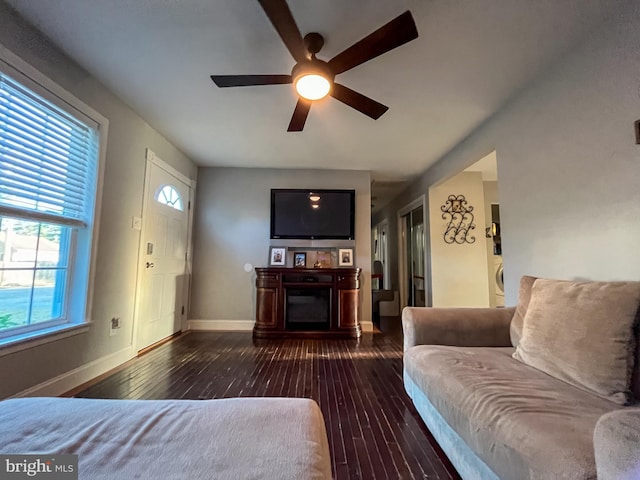 living room featuring dark hardwood / wood-style flooring and ceiling fan