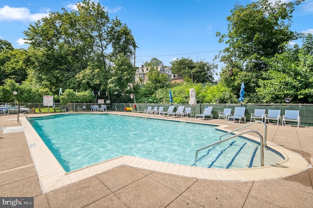 view of swimming pool with a patio area