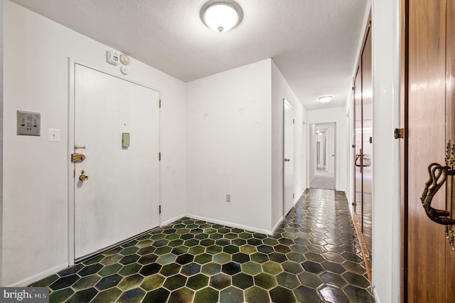 entryway with a textured ceiling