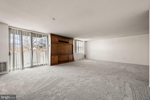 unfurnished living room featuring carpet floors