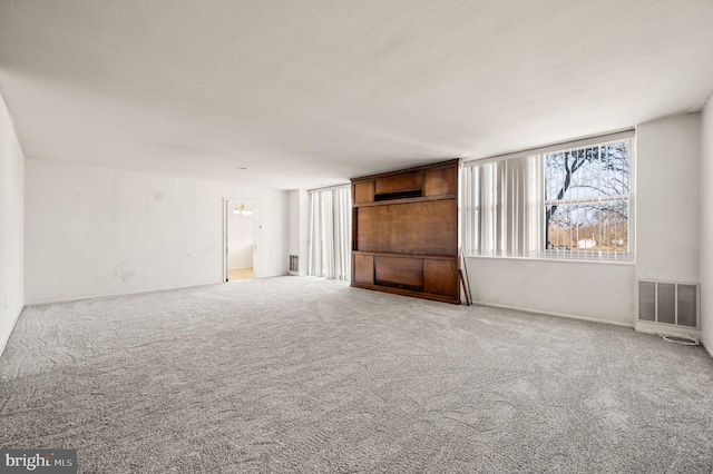 unfurnished living room featuring carpet