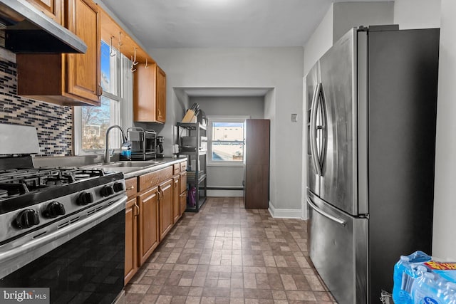 kitchen with decorative backsplash, sink, stainless steel appliances, and plenty of natural light