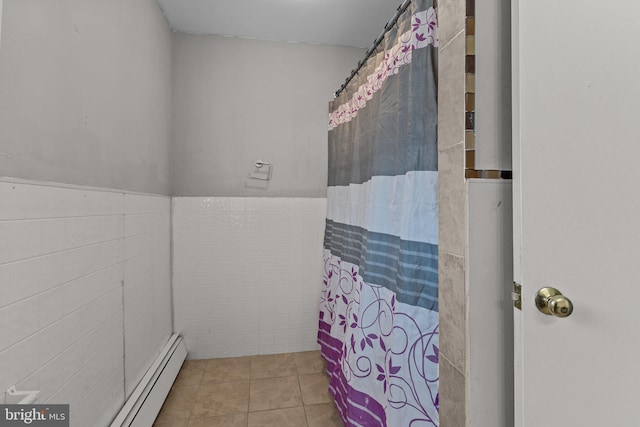 bathroom with tile patterned flooring, a baseboard radiator, and tile walls