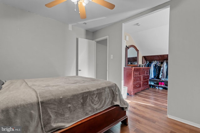 bedroom with wood-type flooring, ceiling fan, and lofted ceiling