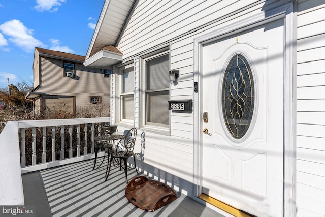 view of exterior entry featuring covered porch