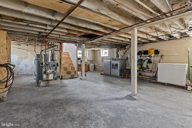 basement with washing machine and dryer and fridge