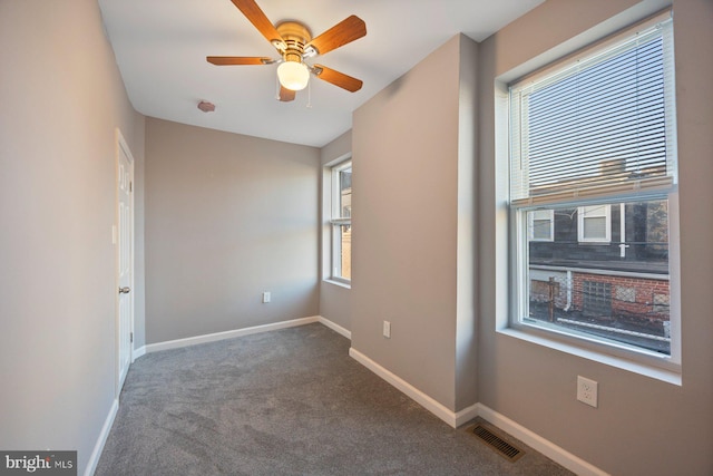 carpeted spare room with ceiling fan