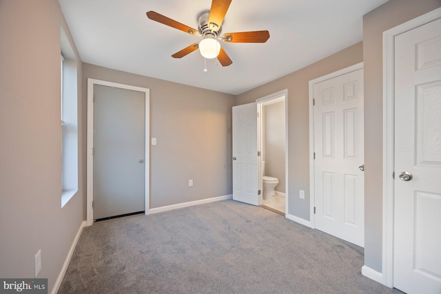 unfurnished bedroom featuring light colored carpet, ceiling fan, and ensuite bathroom