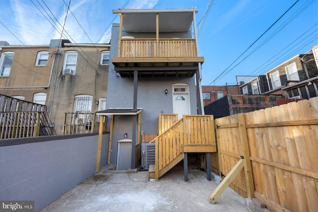 rear view of property with a balcony