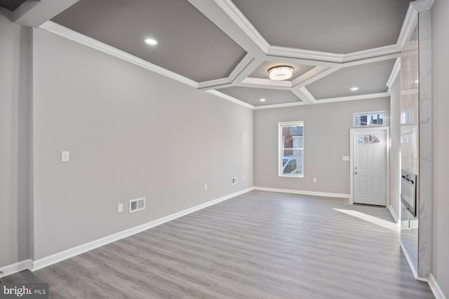 foyer entrance featuring light hardwood / wood-style floors, crown molding, and coffered ceiling