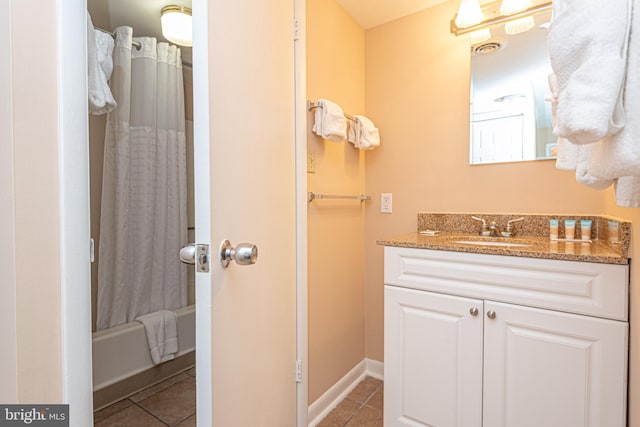 bathroom with tile patterned floors, vanity, and shower / tub combo