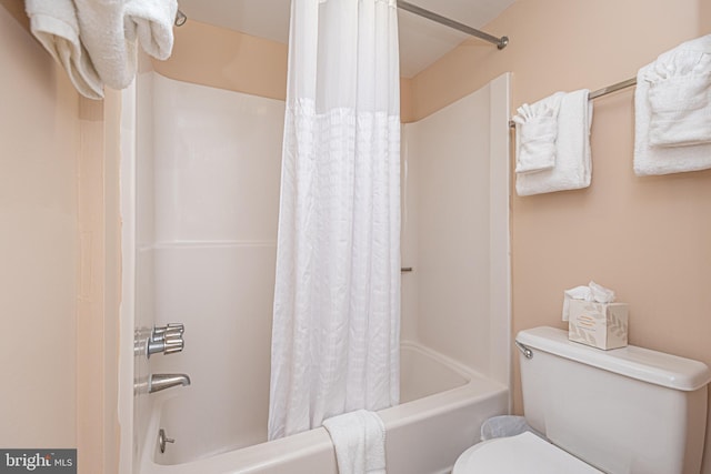 bathroom with toilet and shower / bathtub combination with curtain