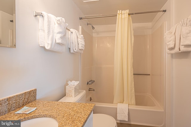 full bathroom featuring shower / tub combo with curtain, vanity, and toilet