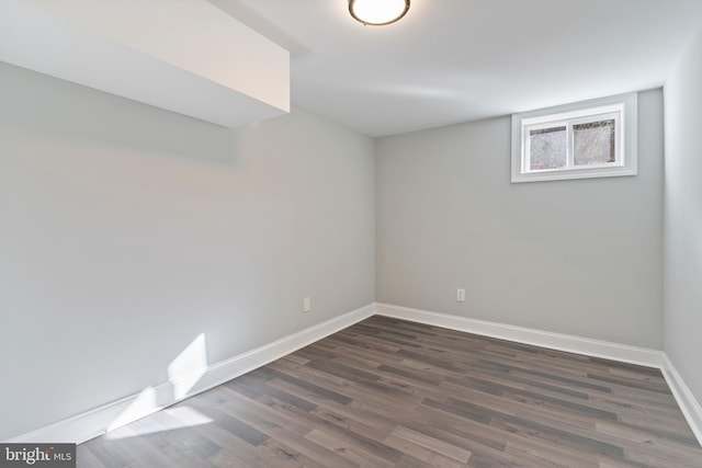 basement with dark hardwood / wood-style flooring