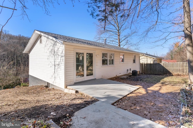 rear view of house with a patio and central AC