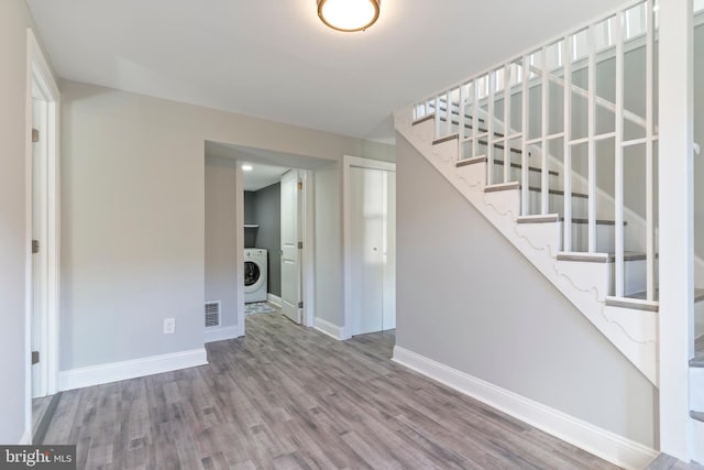 interior space with washer / dryer and hardwood / wood-style flooring